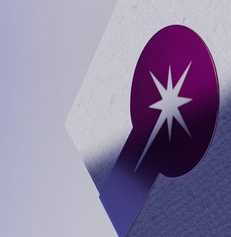 A close-up, angled view of a minimalist product box with a textured, light gray surface. The corner of the box is prominently displayed against a soft purple gradient background.